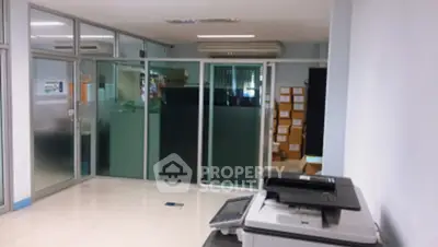 Modern office space with glass partitions and office equipment, ideal for productivity and collaboration.