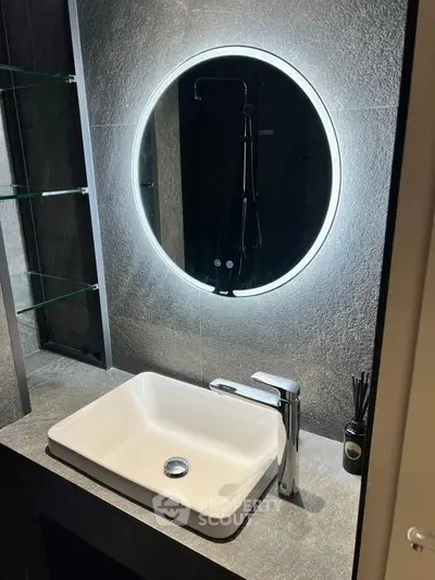 Modern bathroom with illuminated mirror and sleek sink design