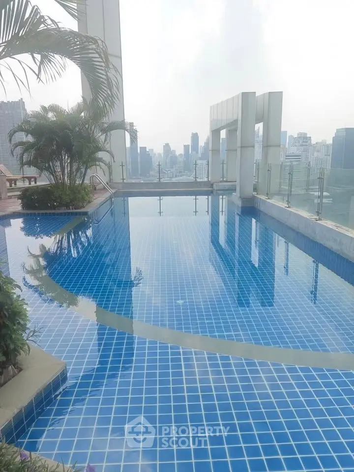 Stunning rooftop pool with city skyline views, perfect for luxury living.