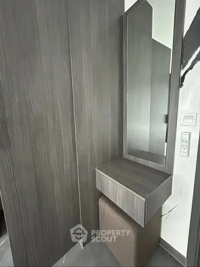 Modern minimalist hallway with sleek wooden paneling and mirror