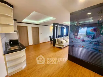Spacious open-plan living room with unique aquarium feature and modern decor.