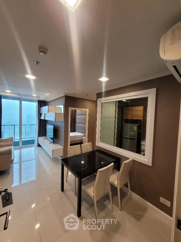 Modern open-plan living and dining area with sleek furniture and large windows offering a stunning view.