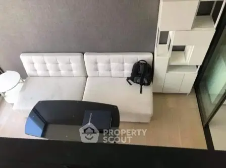 Modern living room with stylish white sofa and sleek black coffee table