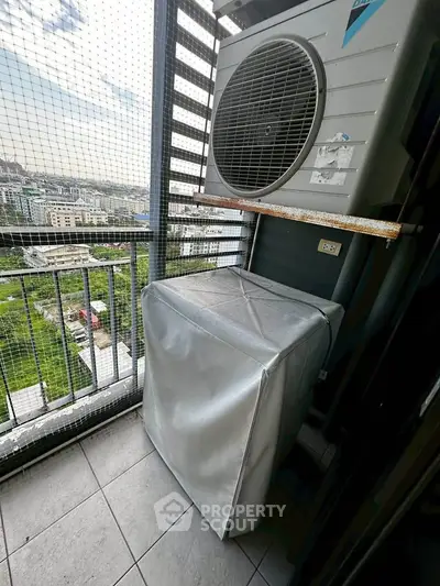 High-rise balcony with air conditioning unit and city view