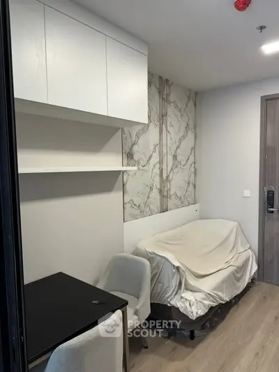 Cozy modern bedroom with marble accent wall and minimalist furniture