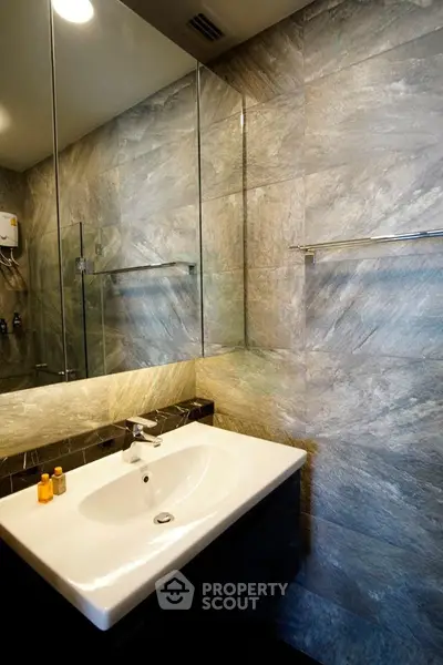 Modern bathroom with sleek sink and elegant stone wall tiles
