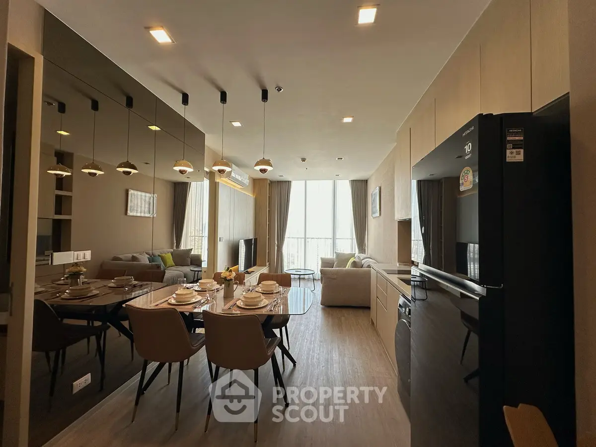 Modern open-layout living and dining area with stylish furniture and natural light.