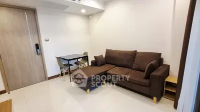 Modern living room with brown sofa and dining table, ideal for cozy gatherings.