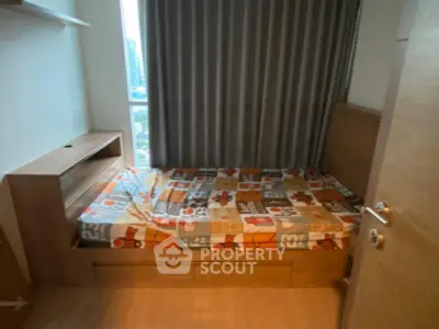 Cozy bedroom with city view, featuring modern furnishings and ample natural light.