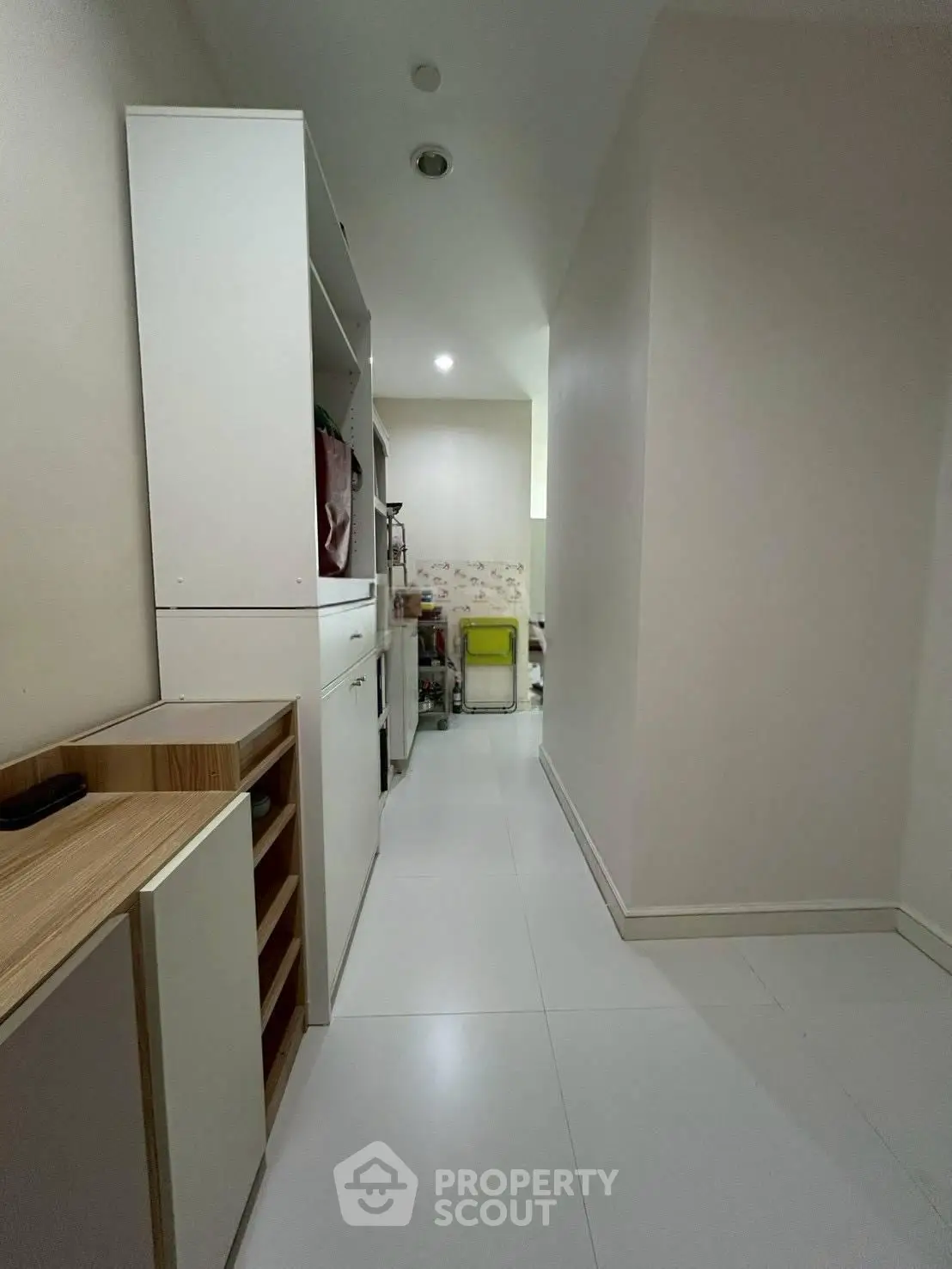 Spacious storage area with sleek white cabinetry and modern design