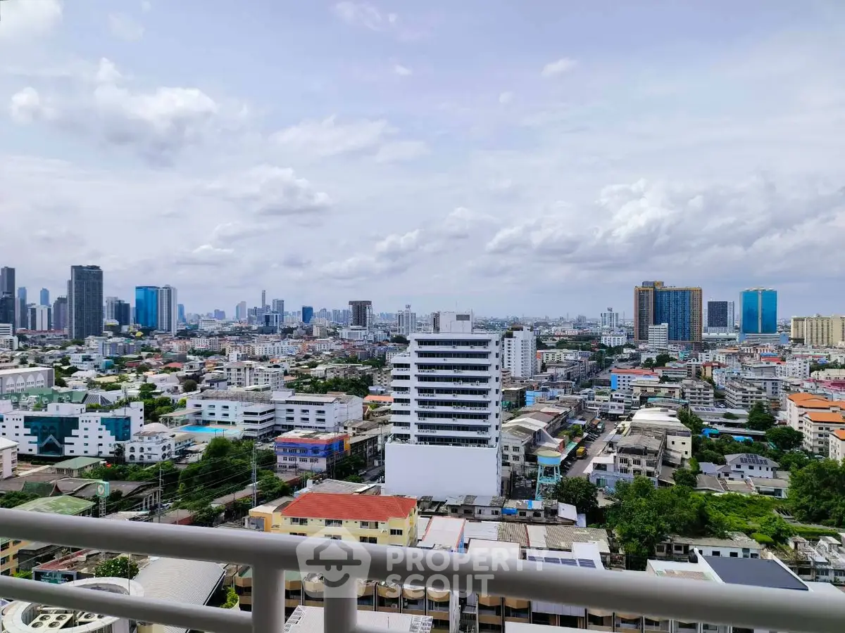 Stunning cityscape view from a high-rise balcony showcasing urban skyline and vibrant city life.