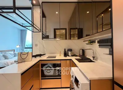 Modern kitchen with sleek cabinetry and integrated appliances in a stylish apartment.