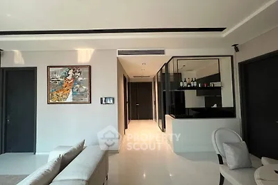Modern living room with sleek design and elegant decor, featuring a comfortable sofa and stylish artwork.