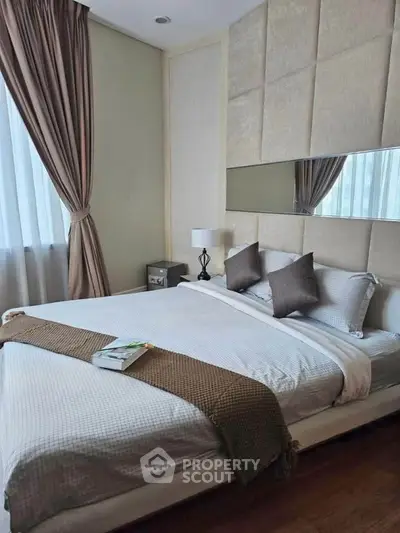 Luxurious bedroom with elegant decor and plush bedding in a modern apartment.