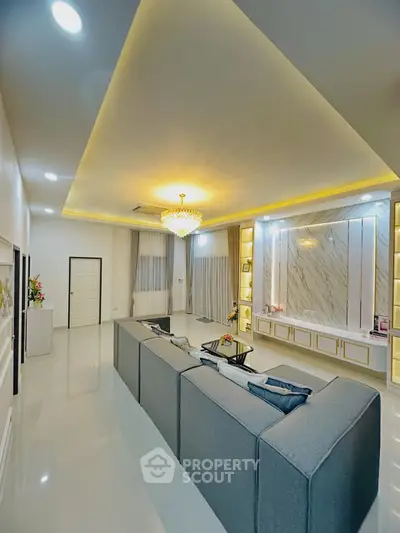 Luxurious modern living room with elegant lighting and spacious seating area.