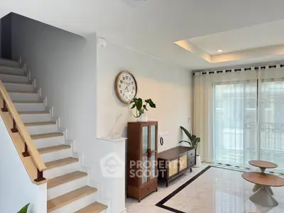Modern living room with elegant staircase and stylish furniture