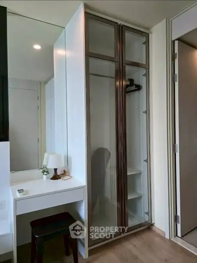 Modern bedroom with sleek wardrobe and minimalist desk setup