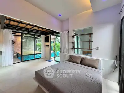 Modern bedroom with pool view and open layout in luxury home