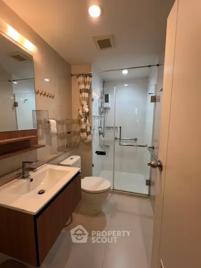 Modern bathroom with sleek fixtures and glass shower enclosure