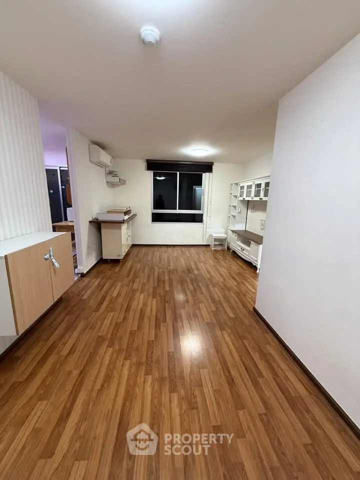 Spacious open-plan living area with wooden flooring and modern cabinetry, perfect for contemporary living.