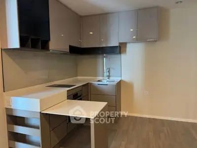 Modern kitchen with sleek cabinetry and integrated appliances in a stylish apartment.
