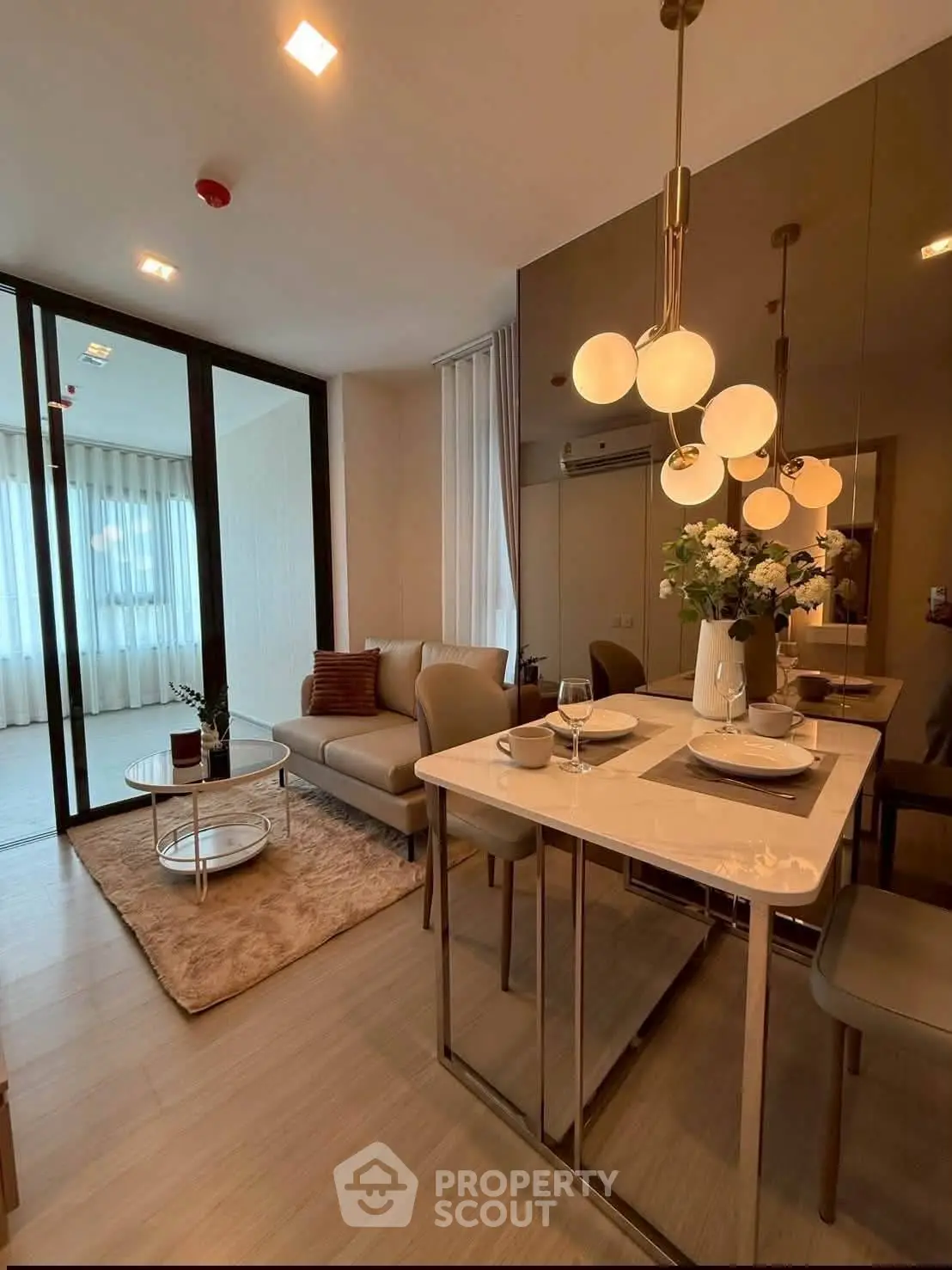 Modern living room with elegant dining area and stylish lighting in a cozy apartment.
