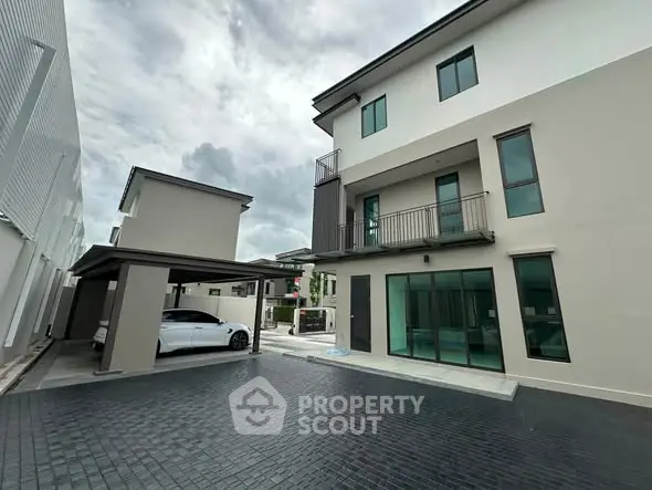 Modern multi-story house with sleek design and spacious driveway