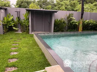 Luxurious private pool with lush green garden in modern villa