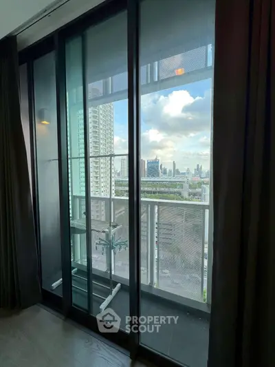 Modern apartment balcony with stunning city view and glass doors