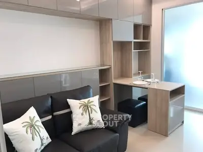 Modern living room with sleek furniture and built-in storage solutions.