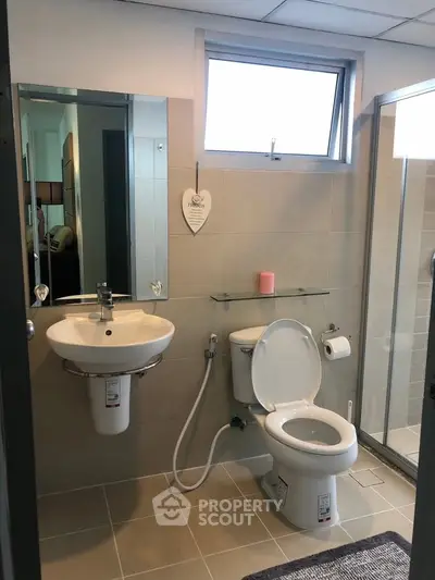 Modern bathroom with sleek fixtures and glass shower enclosure