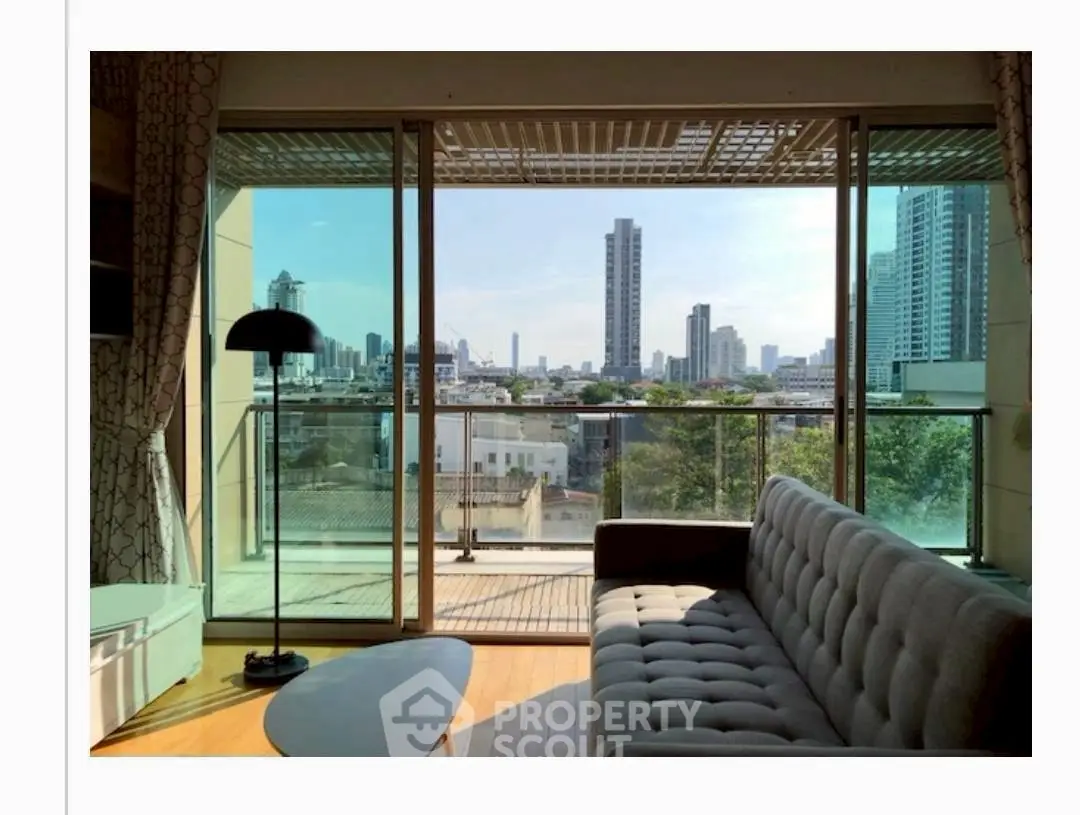Spacious living room with stunning city view and large balcony in modern apartment.
