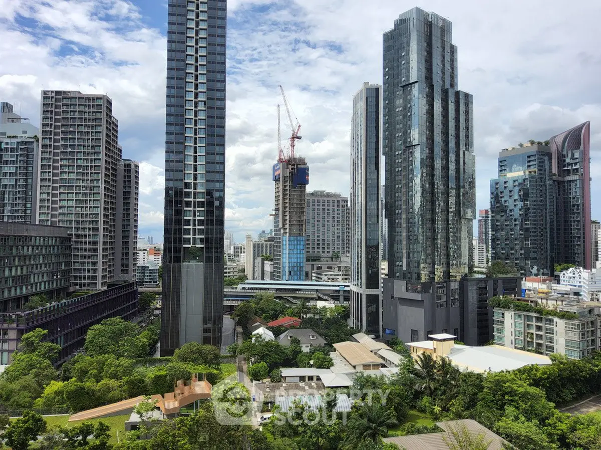 Stunning cityscape view with modern skyscrapers and lush greenery, showcasing urban living at its finest.