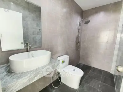 Modern bathroom with sleek fixtures and elegant gray tiles
