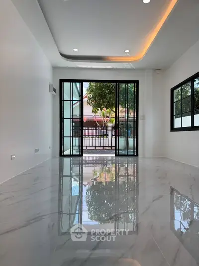 Spacious modern living room with glossy marble floors and large windows