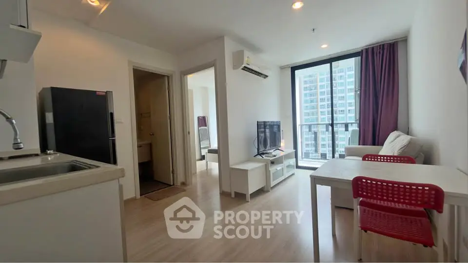 Modern living room with balcony view in high-rise apartment