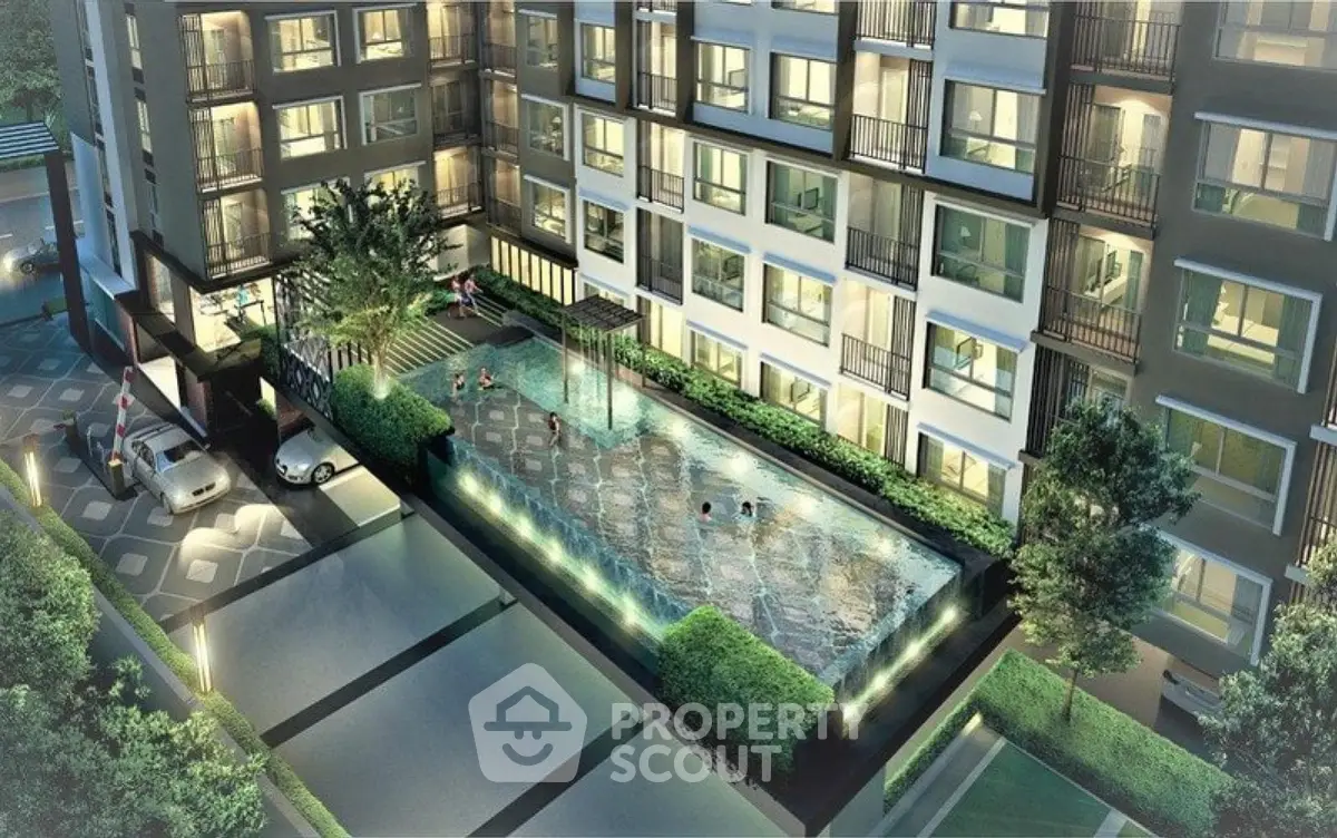 Luxurious modern apartment building with illuminated pool and lush greenery