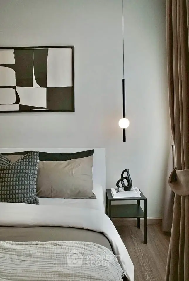 Modern bedroom with stylish decor and cozy ambiance, featuring elegant lighting and contemporary artwork.