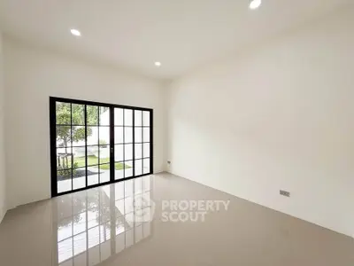 Spacious empty room with large windows and glossy tiled floor, perfect for customization.