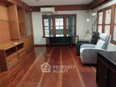 Spacious living room with wooden flooring and comfortable seating