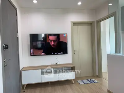 Modern living room with wall-mounted TV and sleek furniture