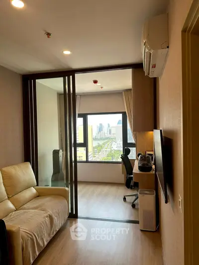 Modern living room with city view, featuring sleek furniture and glass partition for a stylish urban lifestyle.