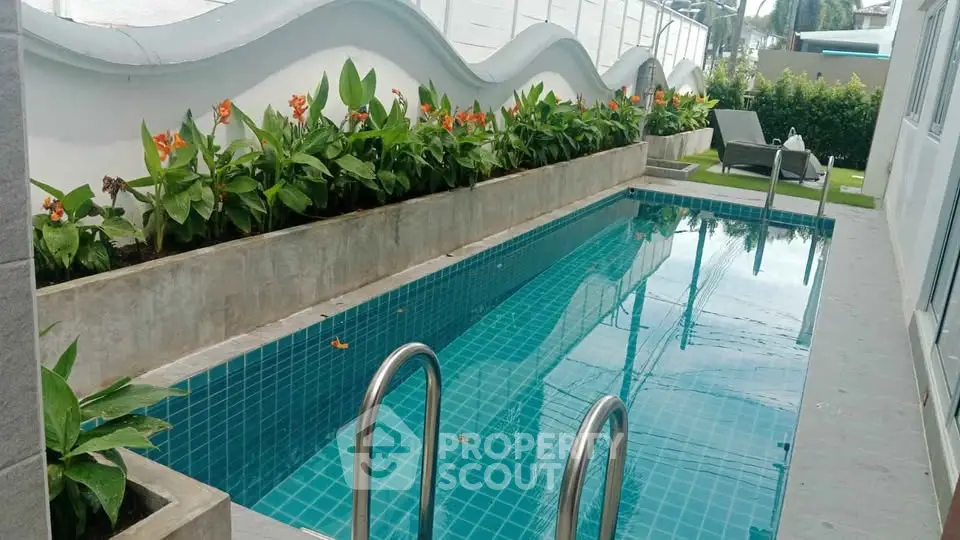 Charming private pool with lush greenery and modern design for a serene retreat.