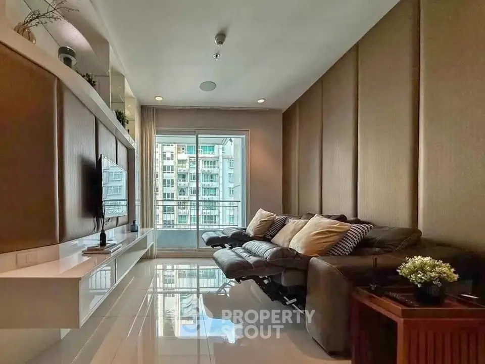 Luxurious living room with modern decor and city view from large windows.