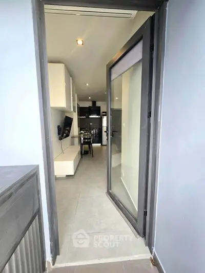 Modern apartment entrance with sleek interior design and open layout.