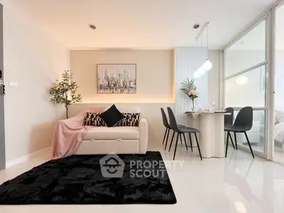 Modern living room with chic decor and dining area, featuring sleek furniture and stylish lighting.