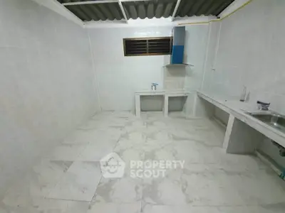 Spacious kitchen with marble flooring and modern ventilation system