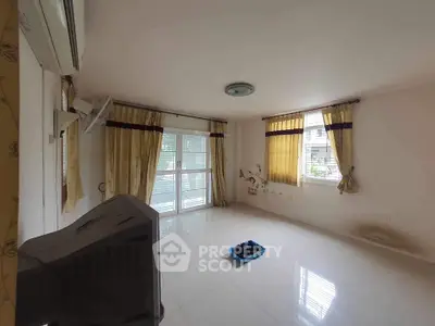 Spacious empty living room with large windows and natural light