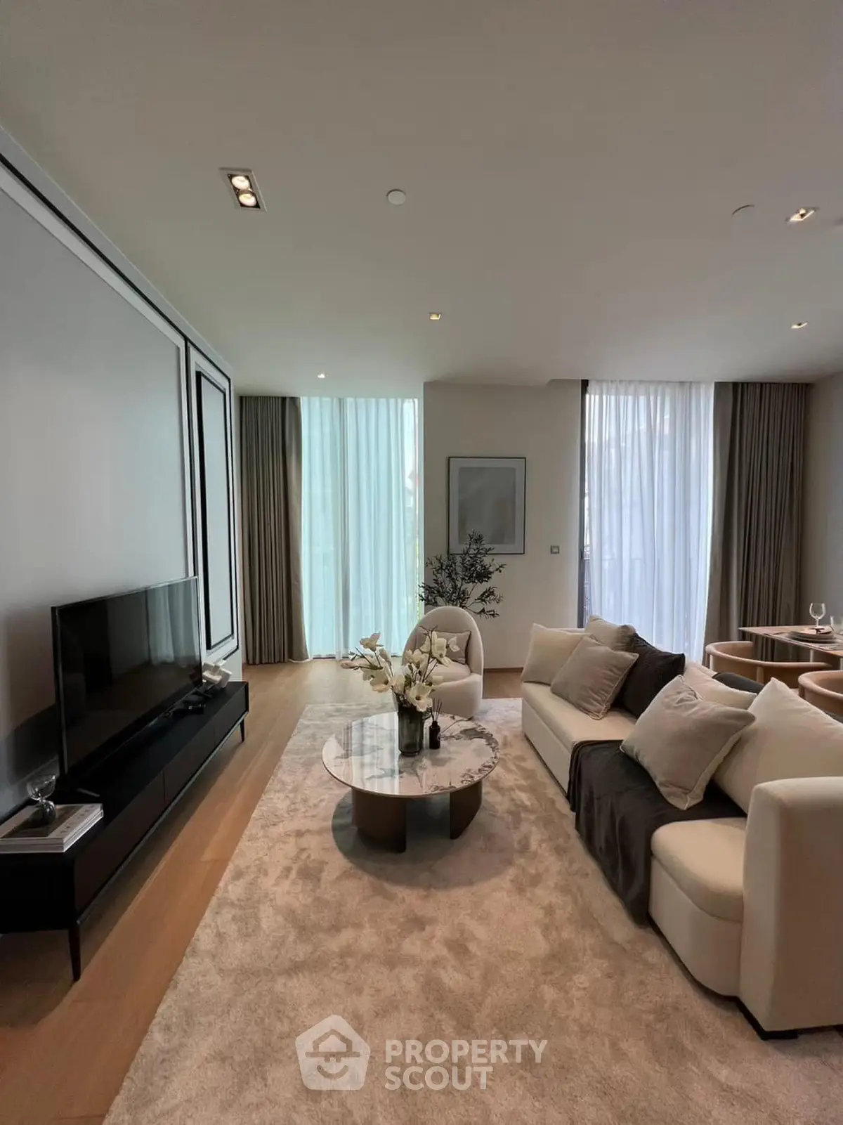Luxurious living room with elegant decor and natural light, featuring modern furniture and stylish accents.