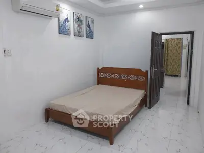 Spacious bedroom with elegant wooden bed and modern decor